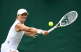 Swiatek downs Wimbledon debutant to reach round two