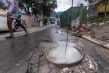 Human waste flows through the streets of Hout Bay