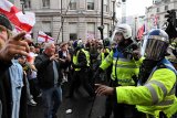 Tens of thousands gather for London anti-immigration march and counter protest