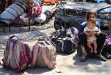 Families leave Gaza City after night of bombardment, Israelis protest