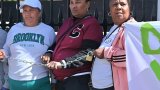 Residents chained to Parliament gates to stop gang violence
