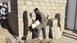 After years on waiting list, man builds house on sports field